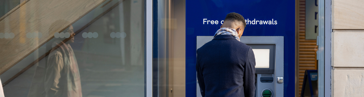 A man withdrawing money from an ATM.