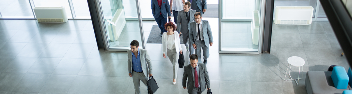Business people walking into an office building.
