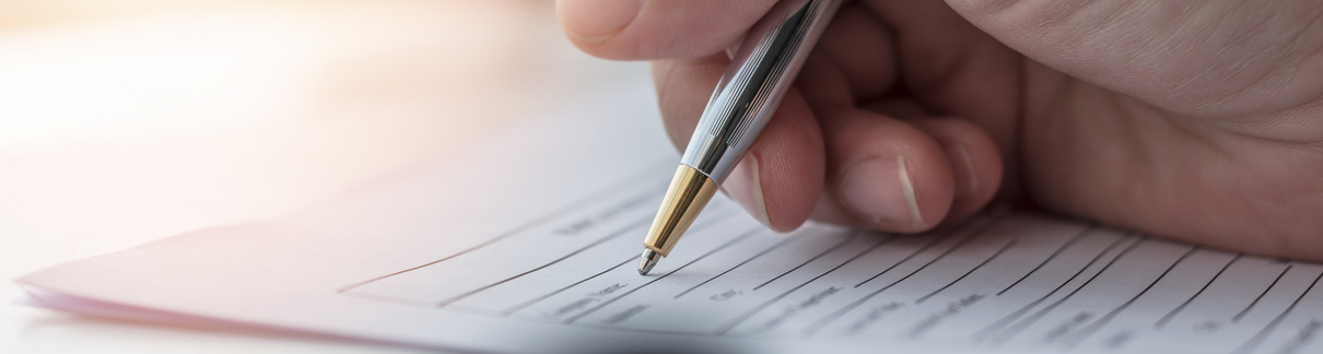 A person filling in paperwork.
