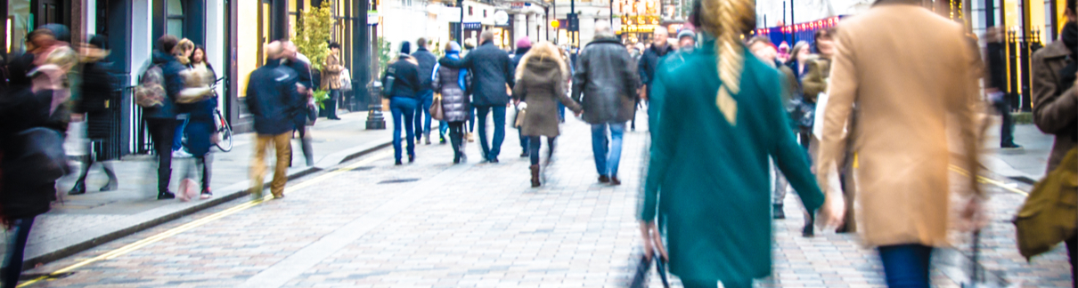 Shoppers walking down a high street.