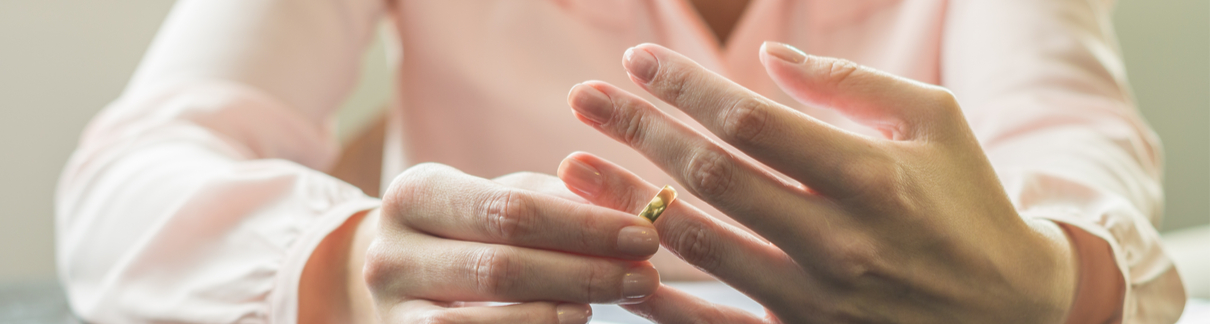 A woman removing her wedding ring.