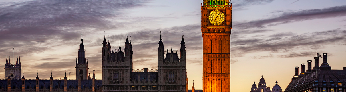 An external image of the Palace of Westminster in the evening