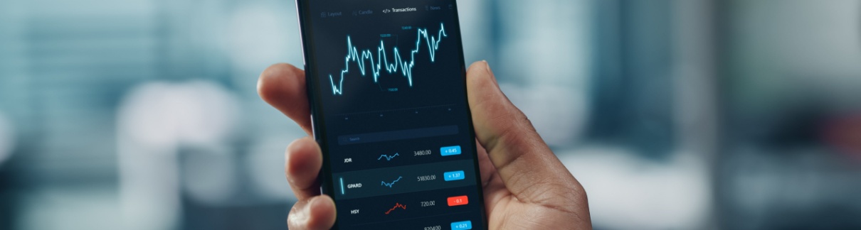 A man looking at stock market performance on his phone.
