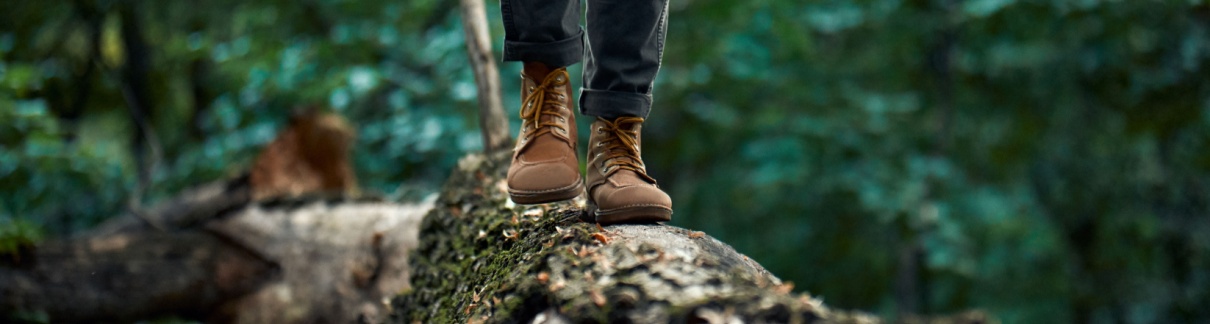 A man walking on a log.