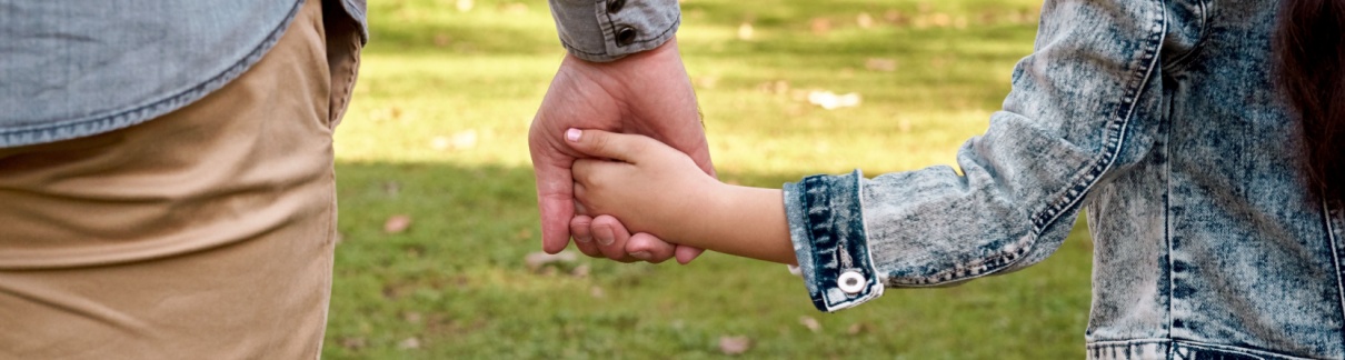 Parent and child holding hands.