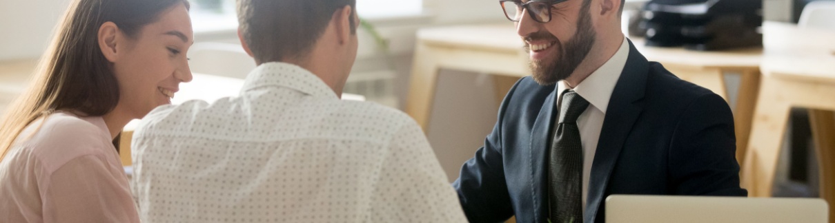 A young couple meeting with a financial planner.