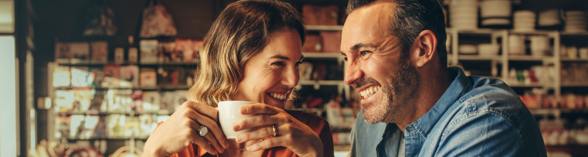 A couple laughing in a café.