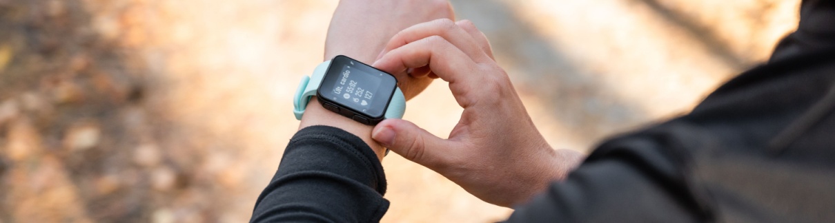 A runner looking at the time on their watch.