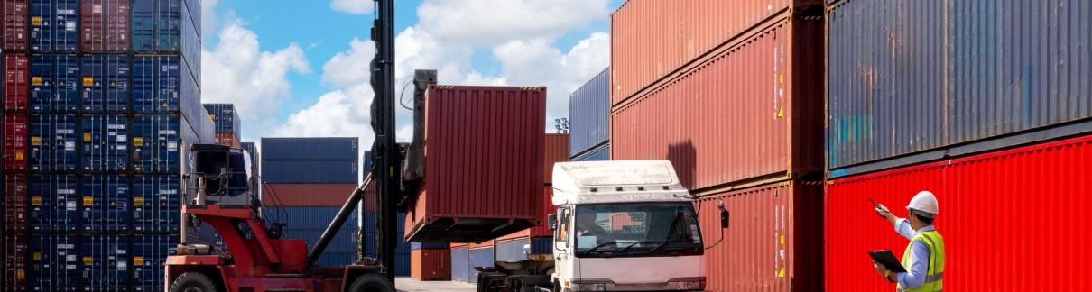 A foreman organising containers from a cargo ship.