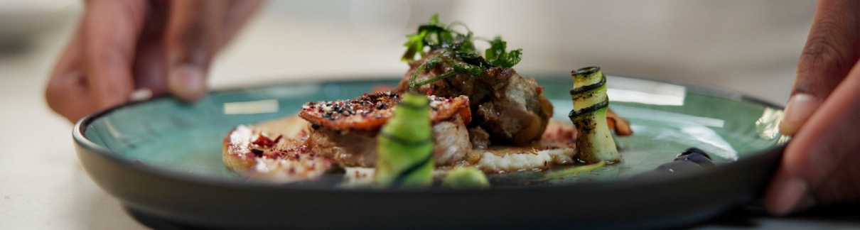 A chef prepares a dish in a fine dining restaurant.