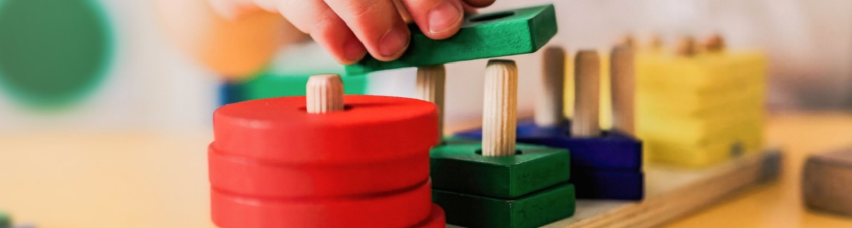 A child playing with wooden shapes.