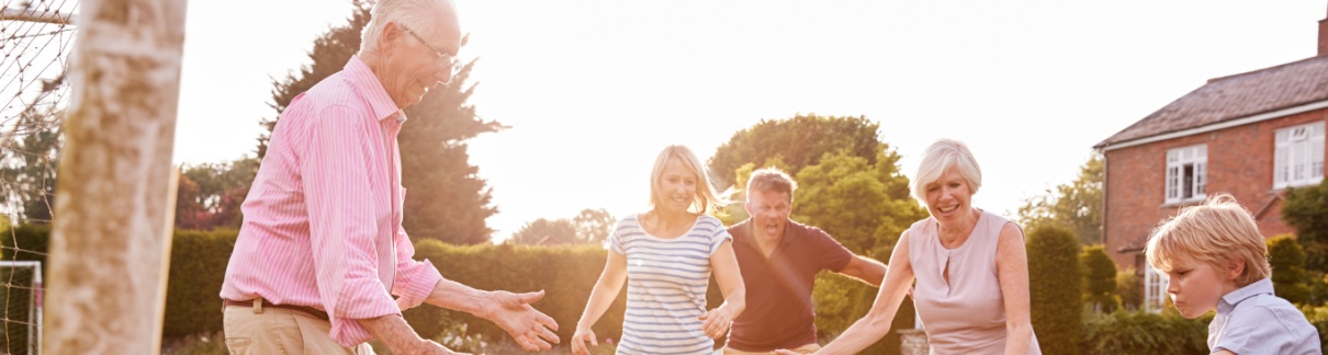 A family playing football in a garden.