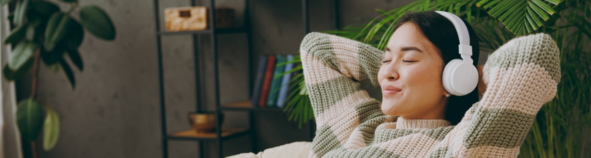 A woman relaxing with headphones on.