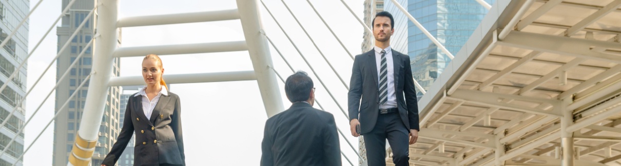 Three office workers crossing on some steps.