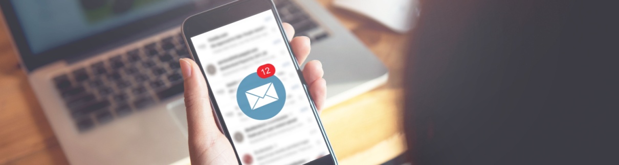 A person looking at their email on their phone.