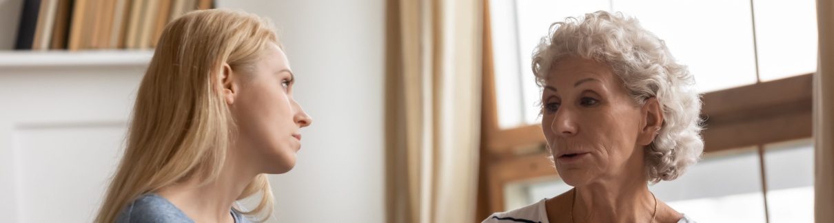 A mother and adult daughter talking.