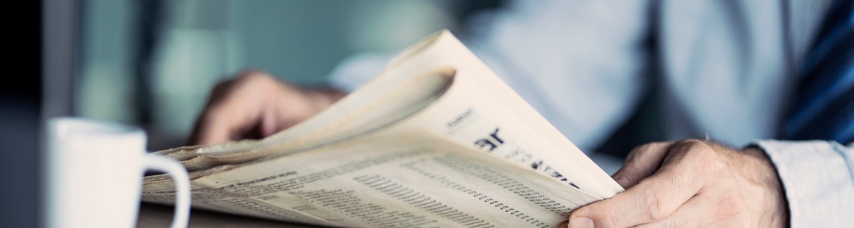 A man reading a newspaper.
