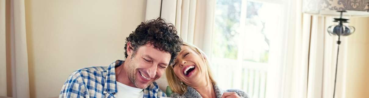 A happy couple reviewing paperwork.