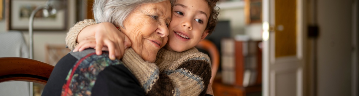 A woman hugging her grandchild.