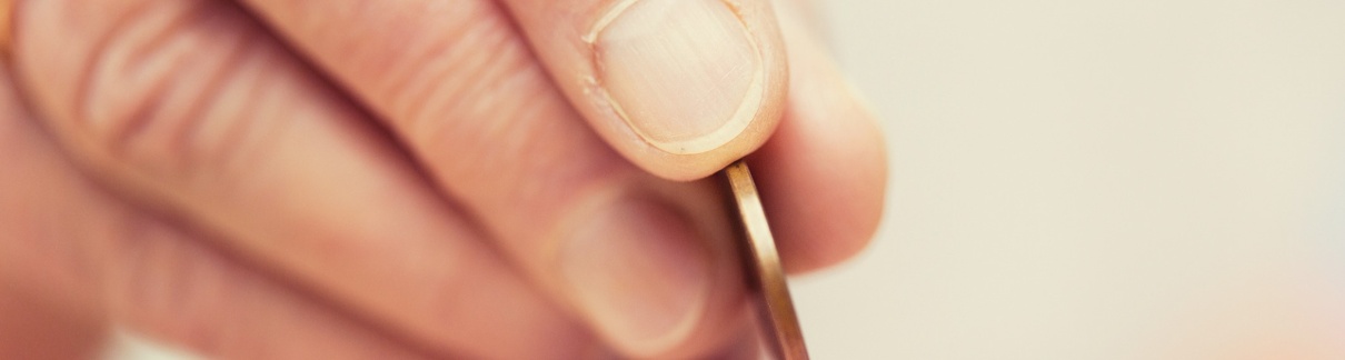 A person putting a coin into a money box.