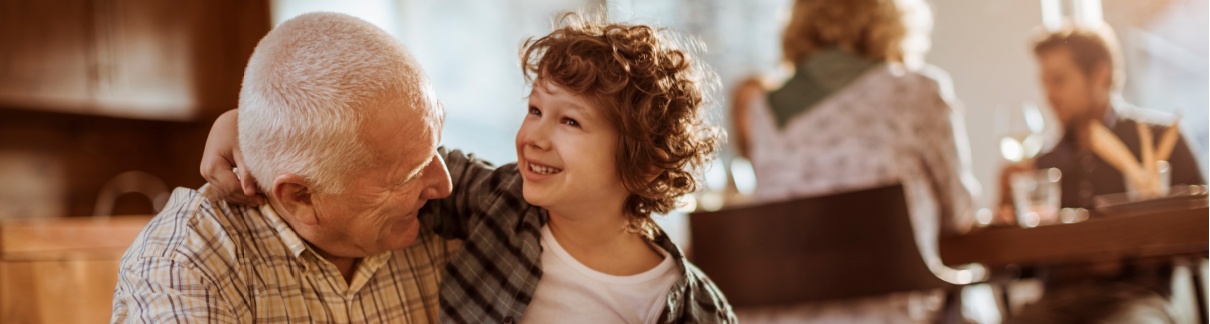 Grandfather hugging his grandchild.