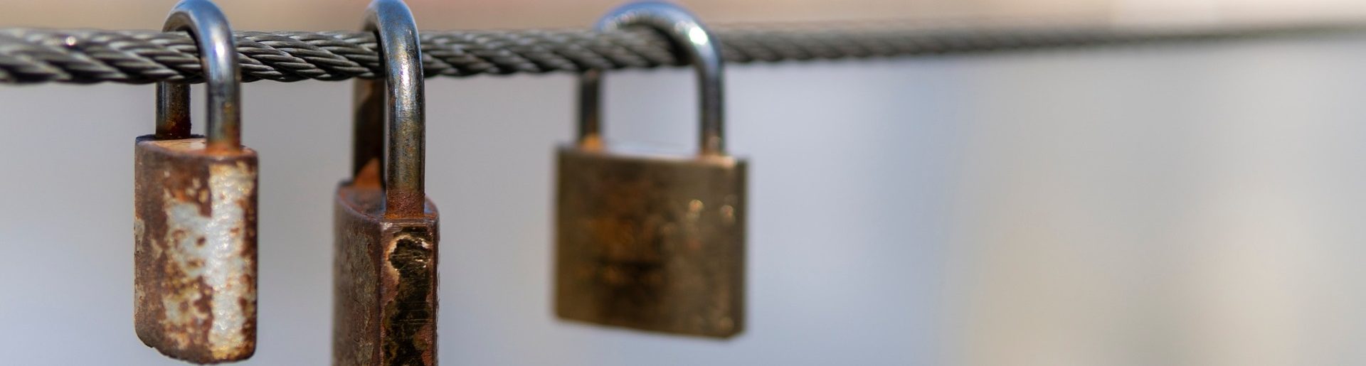 Three padlocks on a chain.