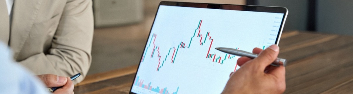 A man reviewing stock market movements on a laptop.