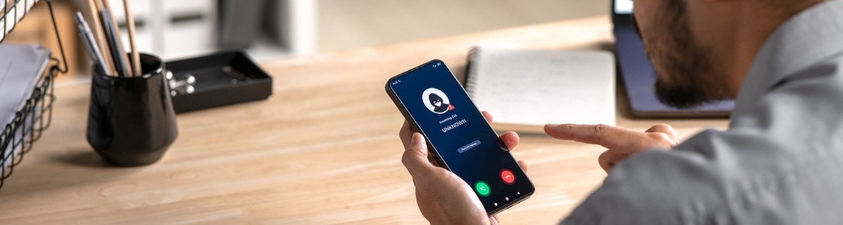 A man receiving a call from an unknown number.